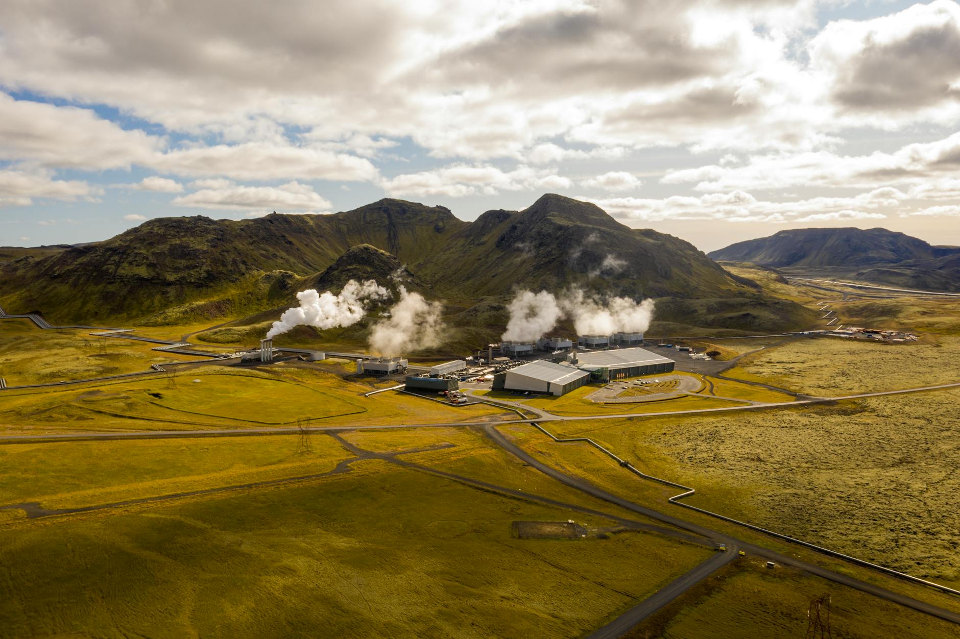 hellisheidi geothermal power plant on grass field under a cloudy sky